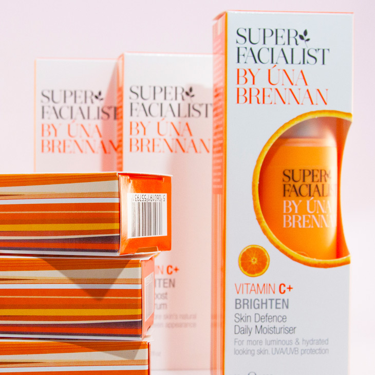 Six orange and white cartons containing skin moisturiser by Super Facialist
